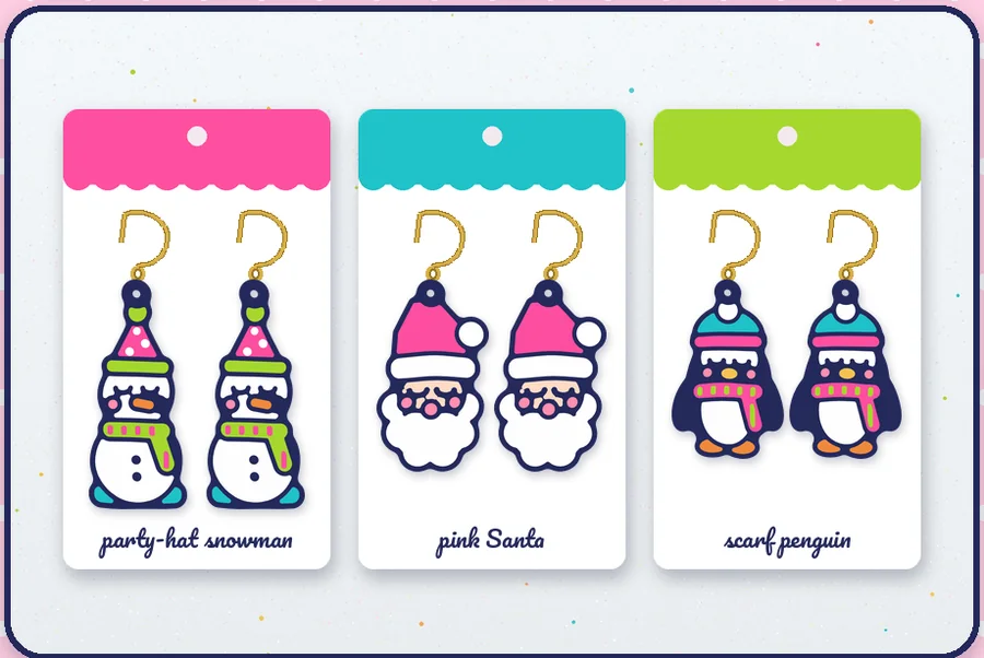 Christmas earring pairs on cards: party-hat snowman, pink Santa and scarf penguin